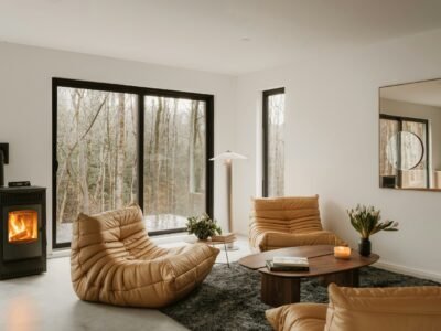 Modern living room with fireplace and forest view